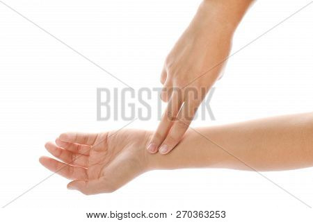 Woman Checking Pulse On Wrist Against White Background, Closeup