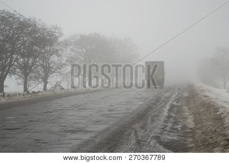 Novopskov, Ukraine - February 03th, 2018: Van Rides The Road Into The Fog. The Concept Of Poor Visib