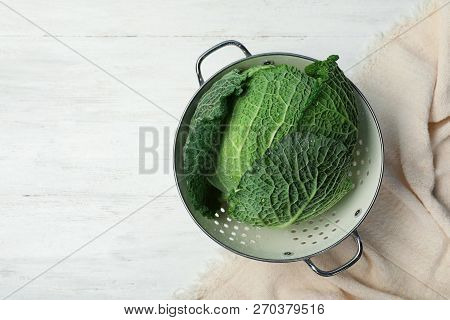 Colander With Savoy Cabbage And Space For Text On White Wooden Background, Top View