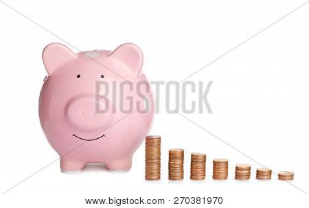 Piggy Bank And Different Height Coin Stacks On White Background. Space For Text