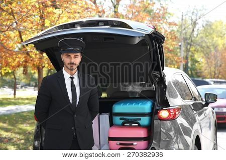Young Driver Standing Near Car With Open Trunk Outdoors