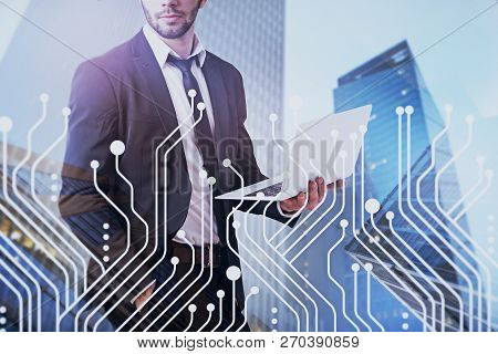 Unrecognizable Businessman With Laptop Standing Over Modern Cityscape Background With Double Exposur