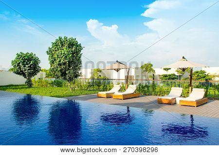 Ajman, United Arab Emirates - 30 October 2018: Pool Area With Sunbeds And Umbrellas In A Luxury Hote