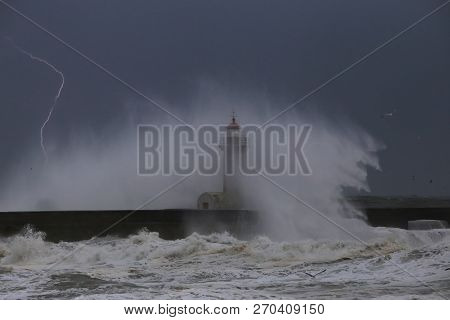 Big Storm With Big Waves Near A Lighthouse