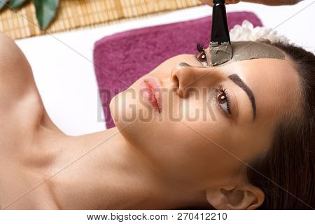 Beautician Applying Enzymatic Peeling On Woman Face In Spa