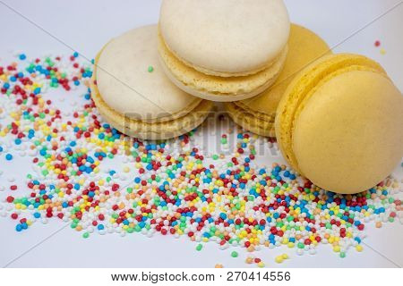 Macaroons Close - Up With Culinary Decor Isolated On A Light Background.