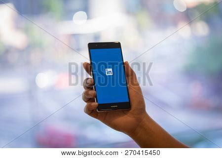 Chiang Mai, Thailand - Oct. 28,2018: Man Holding Huawei Mobile Phone With Linkedin Application On Th