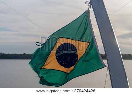 Flag Of Brazil On A River Boat On Amazon River