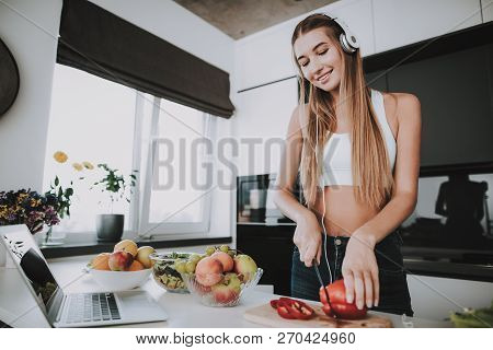 Girl Is Cooking And Listen To Music In Headphones. Healthy Lifestyle. Young And Handsome. Sport Body
