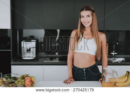 Athletic Girl Stands In Kitchen. Posing Concept. Healthy Lifestyle. Young And Handsome. Sport Body. 
