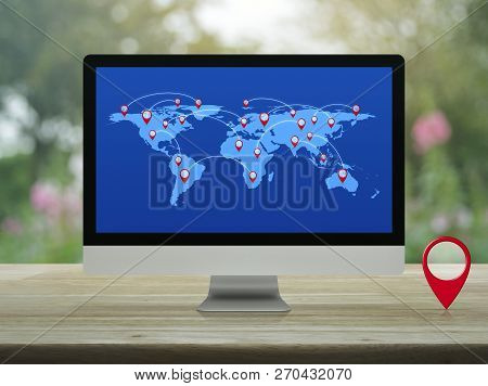 Map Pin Location Button With Connection Line And World Map On Modern Computer Monitor Screen On Wood