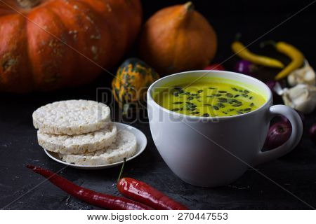Pumpkin Asian Coconat Cream Soup. Autumn Hot Food. Chili Pepper, Garlic, Red Onion, Big Pumpkin. Dar