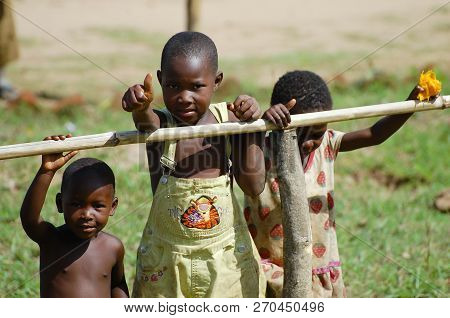 Mzuzu, Malawi - December 9, 2008: Children Waving To Tourists During A Safari Passing Through A Vill
