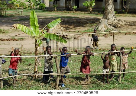 Mzuzu, Malawi - December 9, 2008: Children Waving To Tourists During A Safari Passing Through A Vill