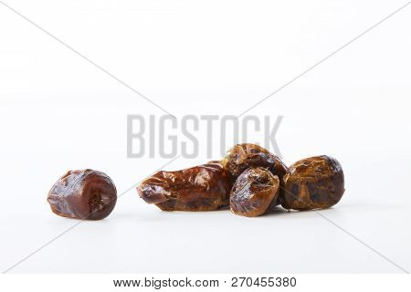 Dried Halawi Dates On A White