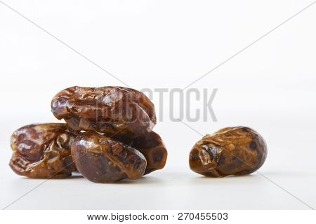 Dried Dates (fruits Of Date Palm Phoenix) On A White Background.