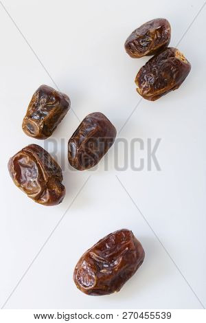 Dried Dates (fruits Of Date Palm Phoenix) On A White Background.