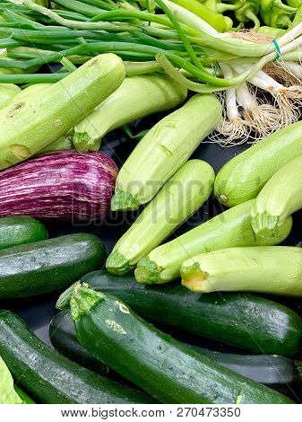 A Close-up Of Fresh, Just Picked Vegetables. The Vivid Colours Of The Light And Dark Green Zucchini,