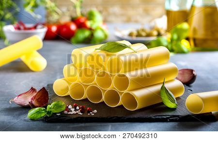 Fresh Raw Homemade Connelloni Pasta On Dark Table.