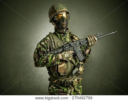Soldier agent in a dark room with arms on his hand and gas mask