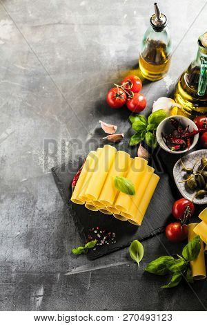 Fresh Raw Homemade Connelloni Pasta On Dark Table.