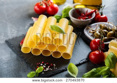 Fresh Raw Homemade Connelloni Pasta On Dark Table.