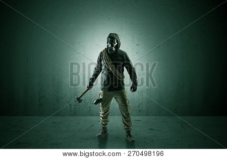 Bad agent in a dark room with arms on his hand and gas mask