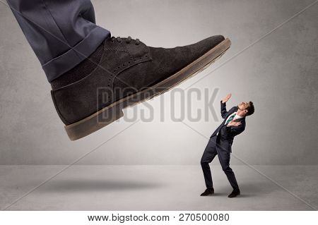 Young businessman illustrated inconsiderable by being trampled