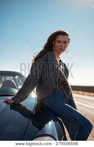 Young Woman Standing Near Roofless Car Outdoors On Sunny Day Near The Road