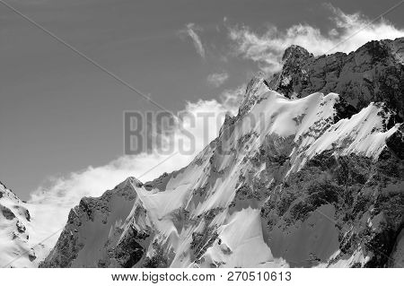 Black And White View On Snowy Mountains And Cloudy Sky At Windy Sun Day. Caucasus Mountains In Winte