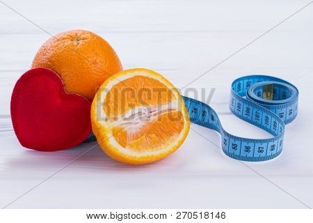 Citrus Fruits, Heart And Measuring Tape. Fresh Oranges Fruits, Tape Measure And Red Heart. Make Your