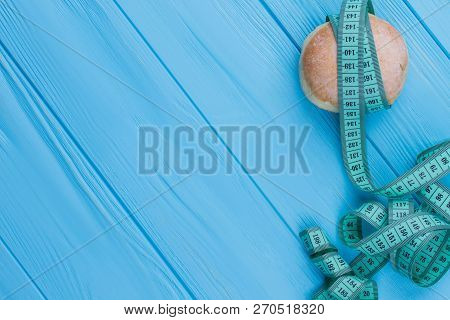Tape Measure Wrapped Around Donut. Healthy Lifestyle And Slimming. Time For Diet.