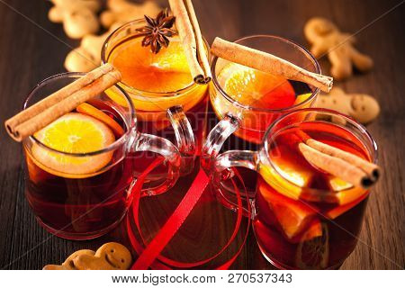 Glintwine With Citrus And Cranberry. Christmas And Winter Warming Beverage On Wooden Background.