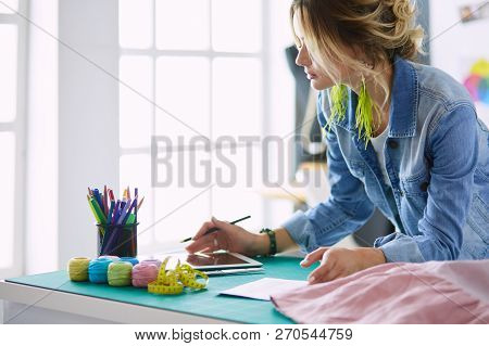 Fashion Designer Woman Working On Her Designs In The Studio