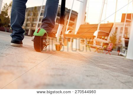 Close Up Image Of A Man On An Electric Scooter.