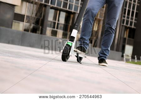 Close Up Image Of A Man On An Electric Scooter.