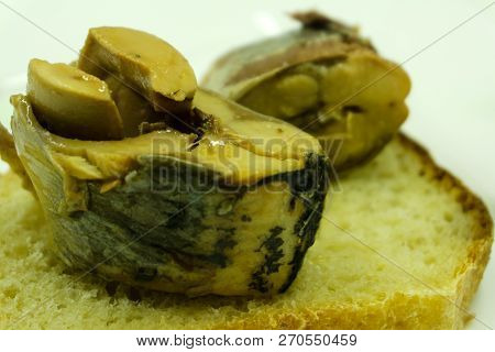 Open Sandwich Made Of Brown Bread And Slices Of Fillet Of Pickled Atlantic Herring On A Saucer Among