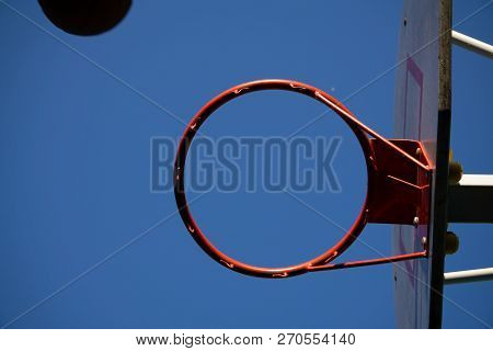 Close Up On A Netball Hoop With Net Against Grey Sky