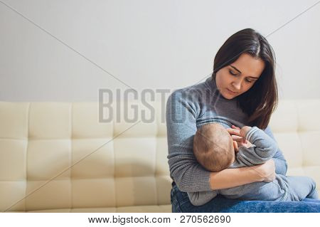 Baby Eating Mothers Milk. Mother Breastfeeding Baby. Beautiful Mom Breast Feeding Her Newborn Child.