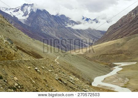 Along The Road A River Flows High In The Mountains Of The Himalayas. Indescribable Beauty.