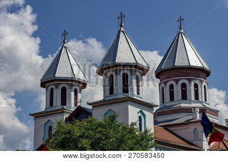 Details Of The Ornate Cupolas On An Orthodox Church In The Village Of Blăjel, Romania Under A Blue S