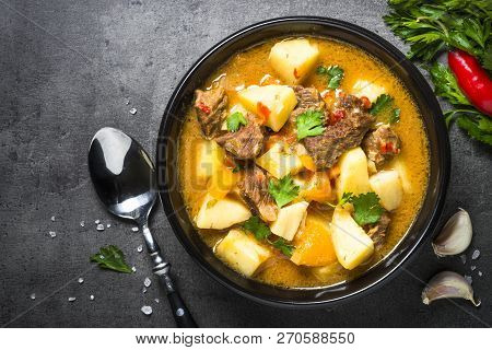 Beef Stew With Vegetables - Carrot, Ppototo And Pumpkin On Black Background.  Top View With Copy Spa