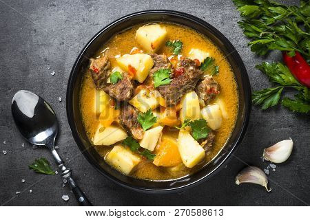Beef Stew With Vegetables - Carrot, Ppototo And Pumpkin On Black Background.  Top View.