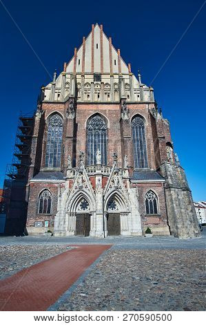 Facade Of A Medieval Roman Catholic Church In The Gothic Style In Nysa