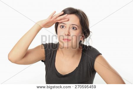 Young Woman In T-shirt Covering Her Eyes To Search For Something