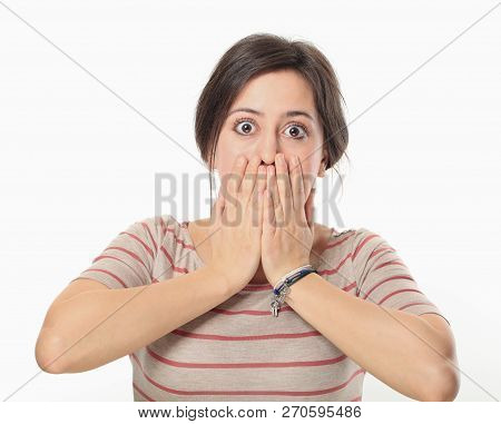 Scared Woman Covering Her Mouth Against White Wall