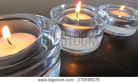 Peaceful Light Of Three Candles In Perspective