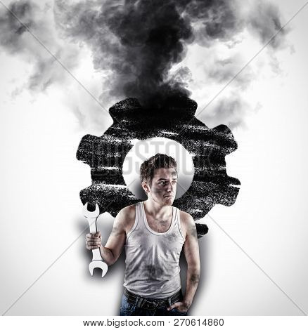 Confused Mechanic Holding A Wrench In Front Of A White Wall. Wall Drawn With A Broken Engine Wheel .