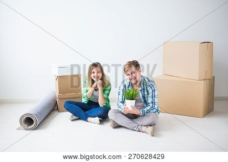 Relocation, Real Estate And Moving Concept - Young Cheerful Couple Moving Into Their New Home