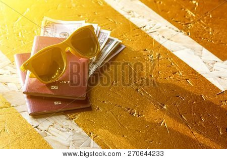 Sunglasses Passport Airplane On Yellow Background In The Sunlight